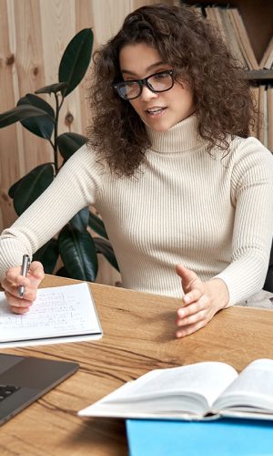 Virtual,Teaching,Concept.,Female,Young,Hispanic,School,Math,Teacher,,College Virtual teaching concept. Female young hispanic school math teacher, college tutor coach looking at webcam and talking in classroom giving remote class online lesson by zoom conference call on laptop.